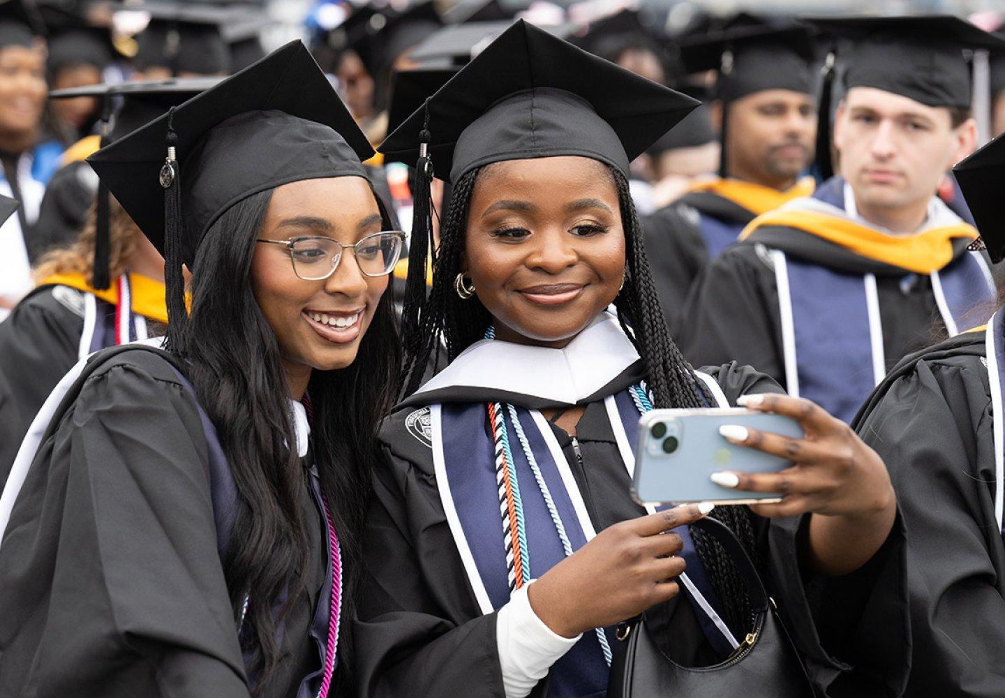 Students pose for a selfie during the undergraduate Commencement exercise Saturday, May 4, 2024.
